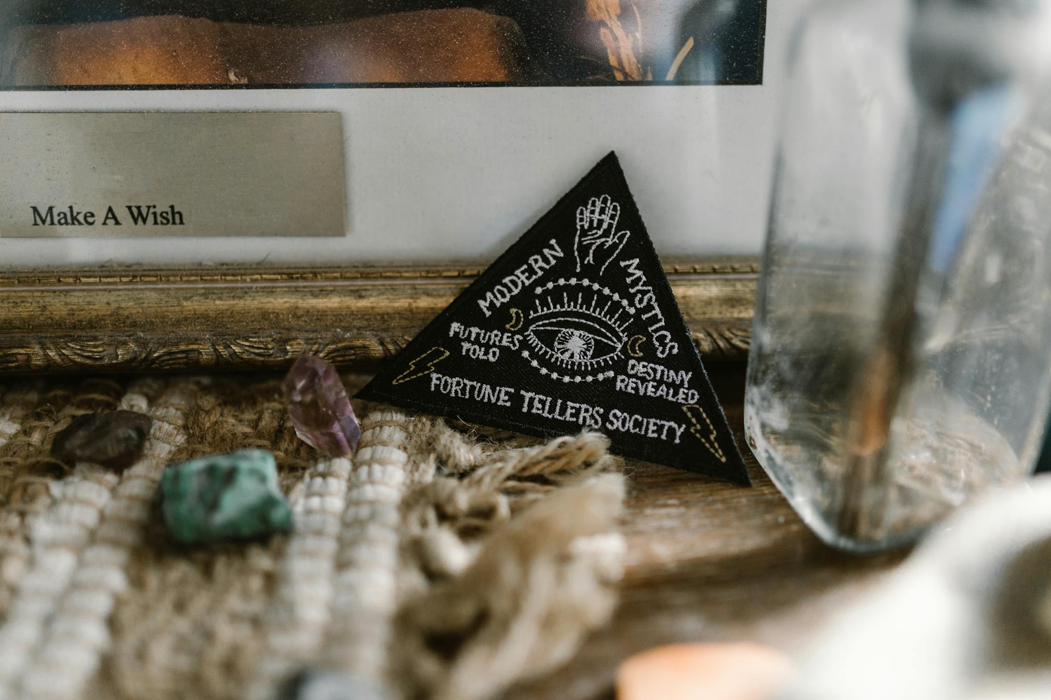 A close-up of a fortune teller's desk featuring crystals and mystic symbols.
